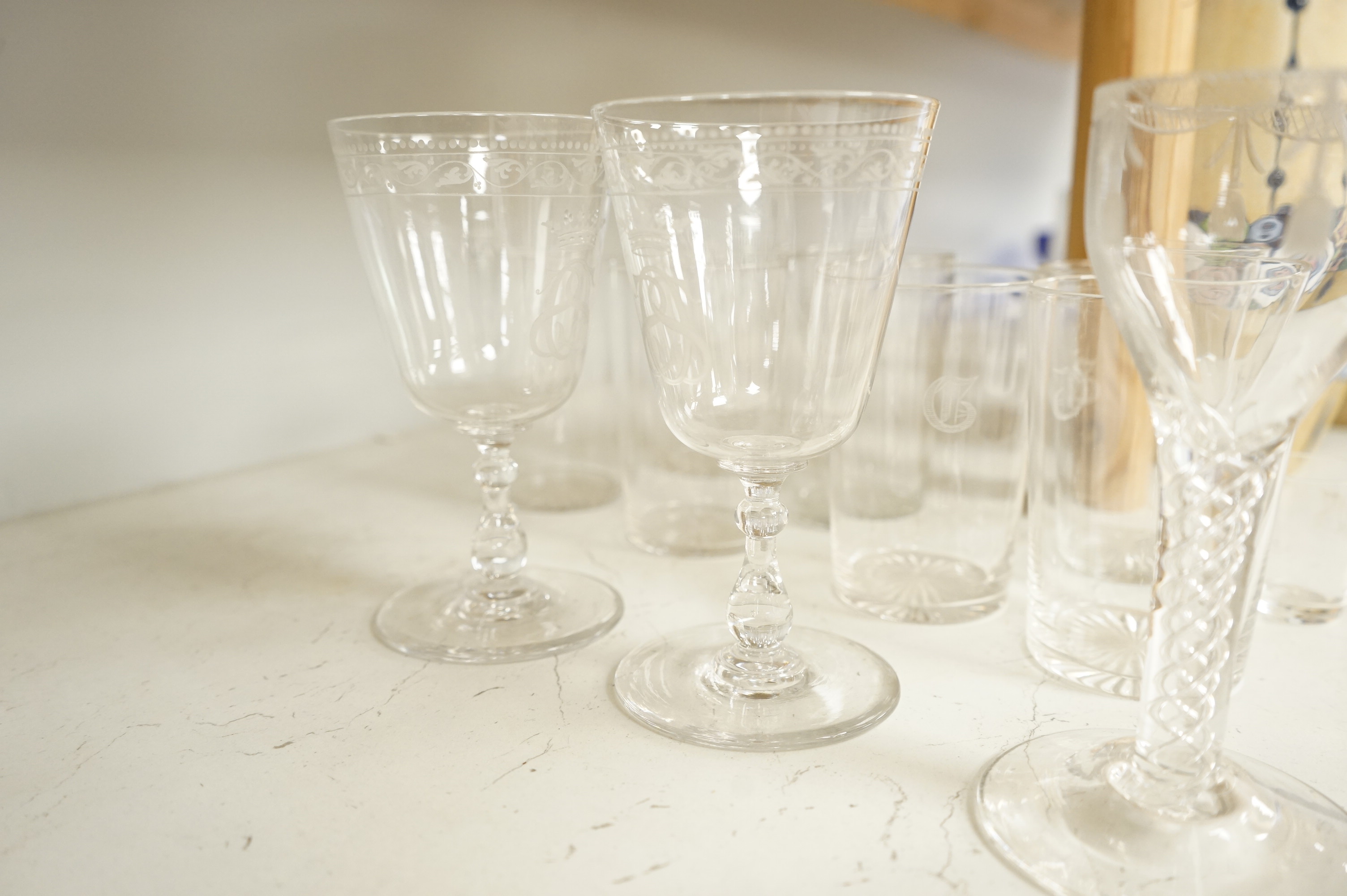 A pair of engraved glass goblets, seven tumblers engraved with the initial G and an air twist stem wine glass, etc. (12)